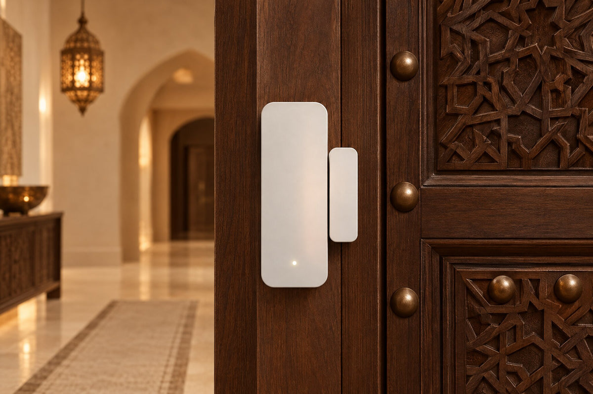 Smart door sensor on a carved Omani wooden front door